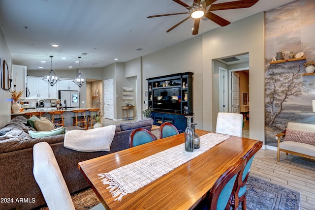 dining room with ceiling fan with notable chandelier