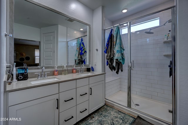 bathroom featuring vanity and a shower with shower door