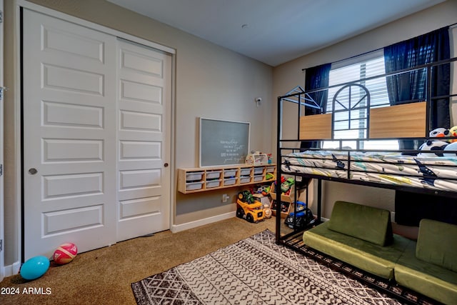 bedroom featuring carpet flooring and a closet