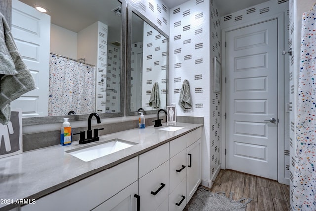 bathroom with vanity and hardwood / wood-style flooring