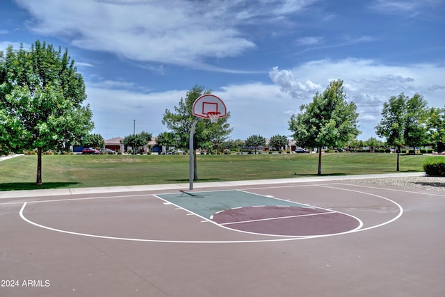 view of basketball court with a yard