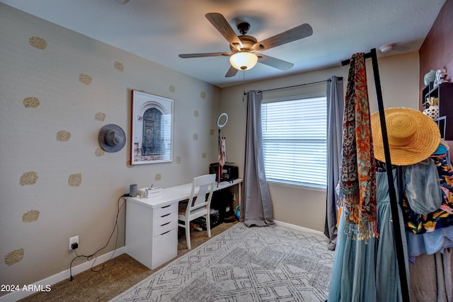 home office featuring ceiling fan and light carpet