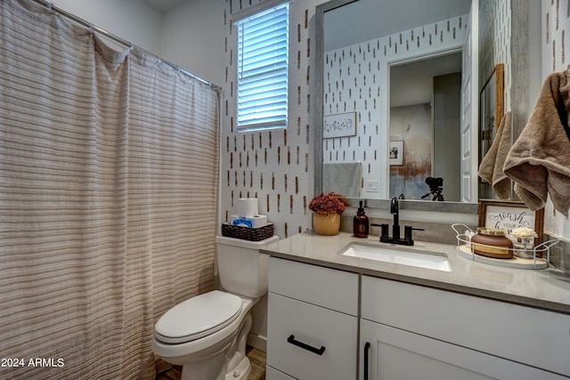 bathroom featuring a shower with shower curtain, vanity, and toilet