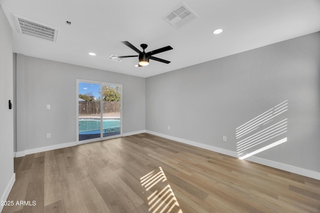 empty room featuring ceiling fan and light hardwood / wood-style floors