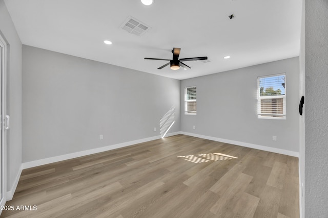 empty room featuring light hardwood / wood-style flooring and ceiling fan