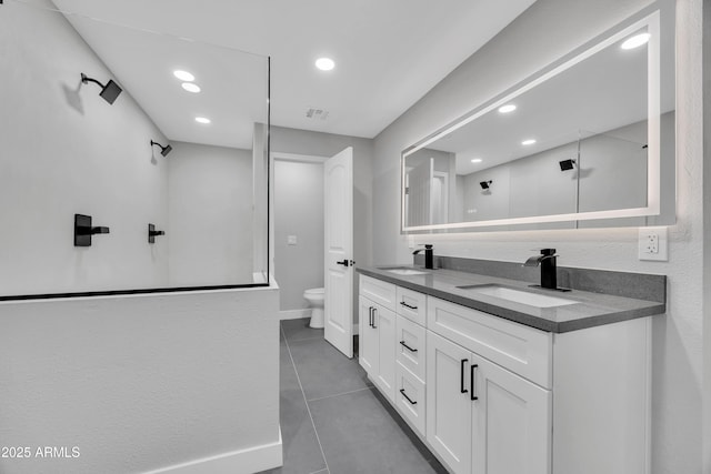 bathroom featuring vanity, tile patterned floors, and toilet