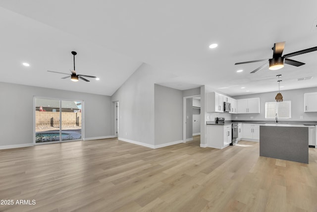 unfurnished living room featuring ceiling fan and light hardwood / wood-style floors