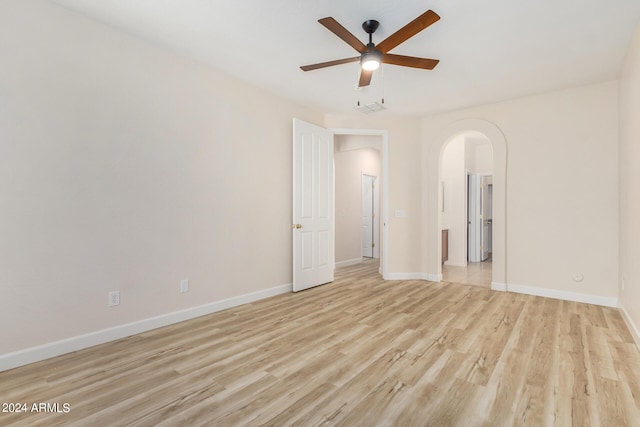 spare room featuring light hardwood / wood-style floors and ceiling fan