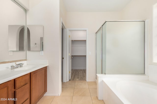 bathroom with vanity, plus walk in shower, and tile patterned floors