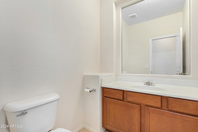 bathroom with toilet and vanity