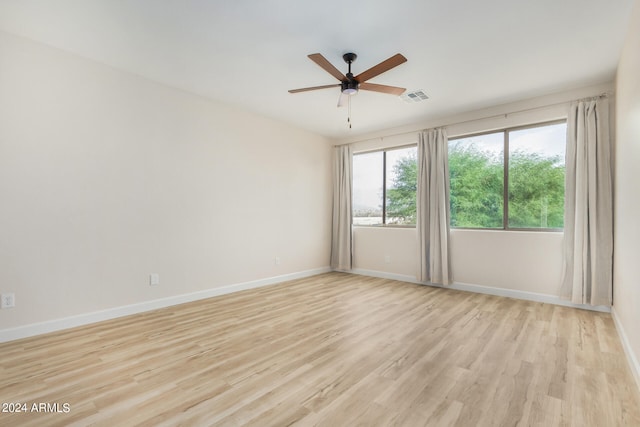 unfurnished room featuring light wood-type flooring and ceiling fan