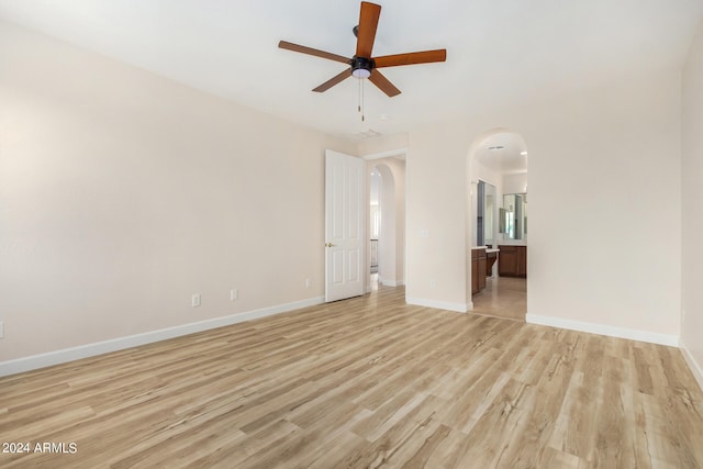 spare room with ceiling fan and light wood-type flooring