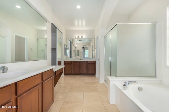 bathroom featuring vanity, shower with separate bathtub, and tile patterned flooring