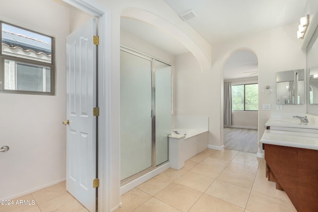 bathroom featuring vanity, independent shower and bath, tile patterned floors, and ceiling fan