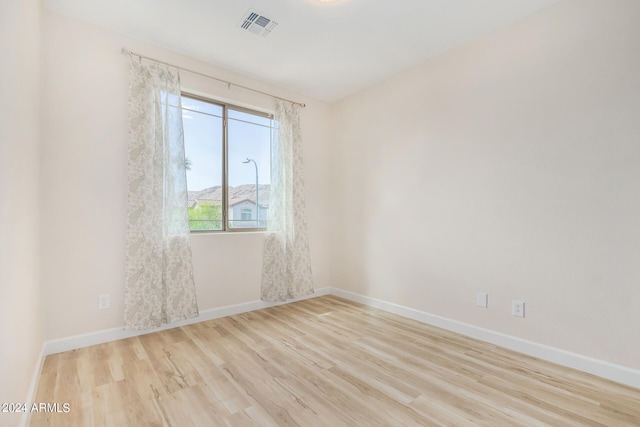 spare room featuring light hardwood / wood-style flooring