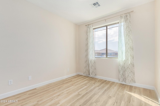 spare room featuring light hardwood / wood-style floors