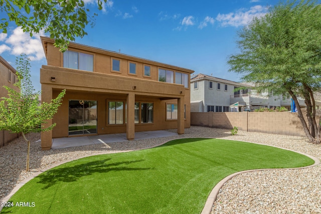 rear view of property with a patio area and a yard