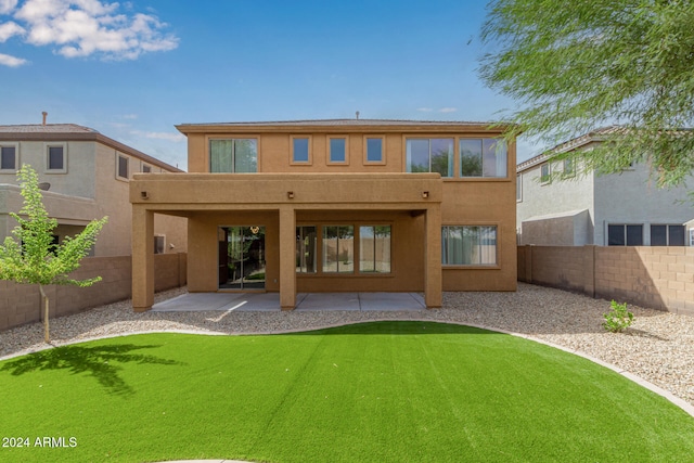 back of property featuring a yard and a patio area