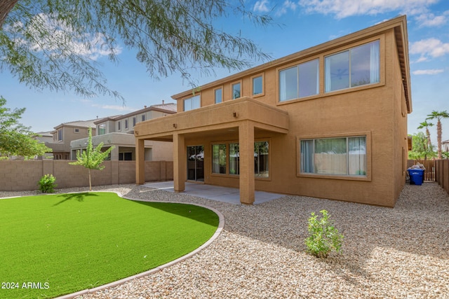 back of house with a patio