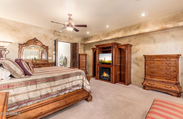 bedroom featuring ceiling fan and light colored carpet