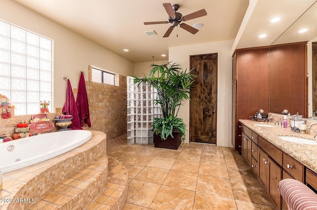 bathroom featuring ceiling fan, separate shower and tub, and vanity