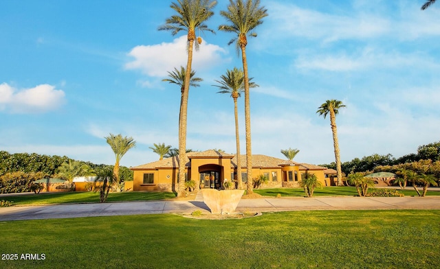 mediterranean / spanish house featuring a front lawn