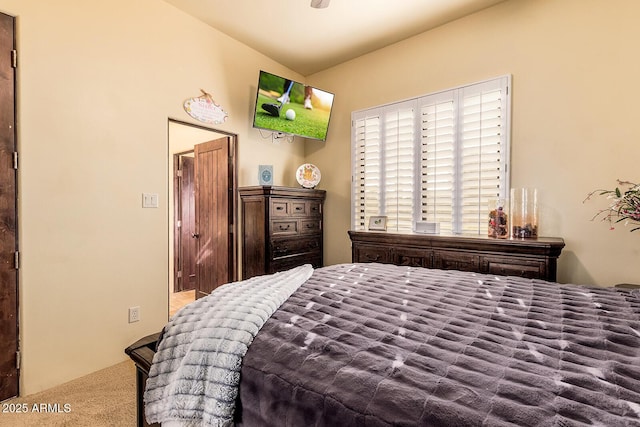 carpeted bedroom featuring vaulted ceiling