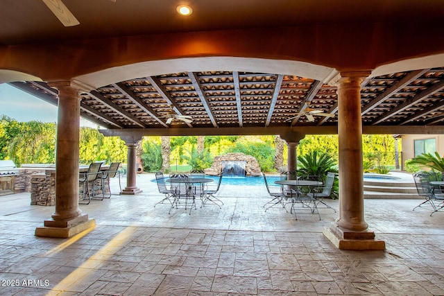 view of patio / terrace with pool water feature and area for grilling