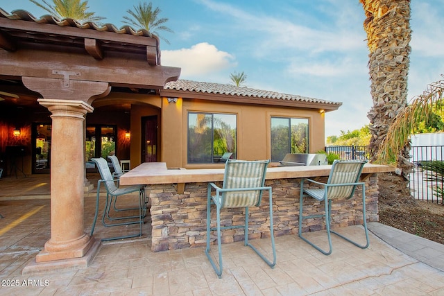 view of patio with an outdoor bar