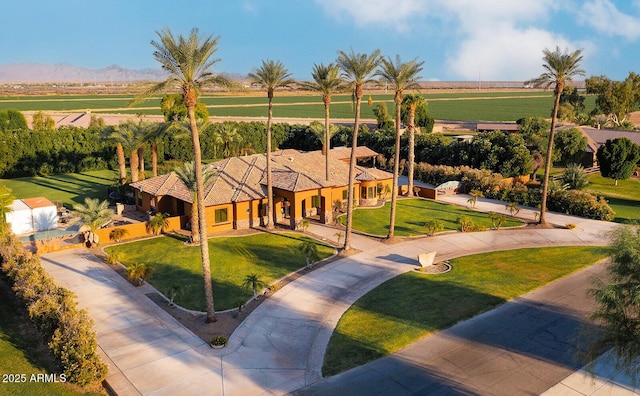 exterior space with a rural view, a front lawn, and a mountain view