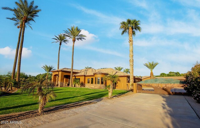 mediterranean / spanish-style house with a front yard