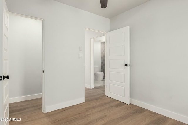 unfurnished bedroom featuring light wood finished floors, ceiling fan, and baseboards