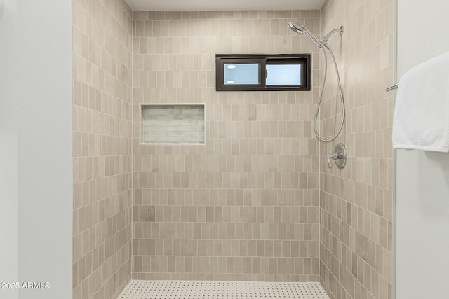 bathroom with tiled shower