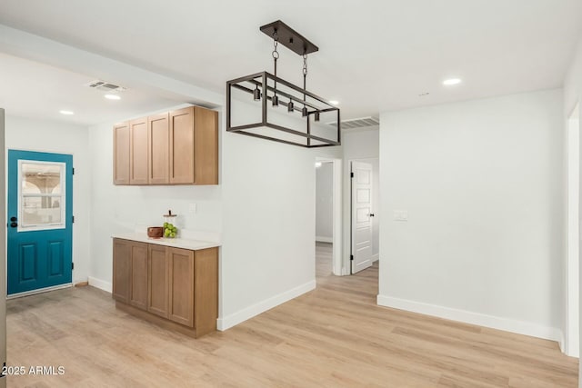 interior space featuring light wood finished floors, visible vents, baseboards, light countertops, and recessed lighting