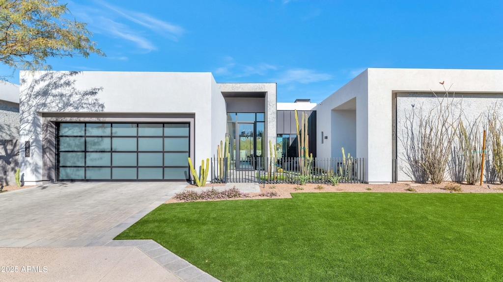 contemporary home featuring a front yard and a garage