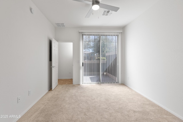 empty room featuring carpet floors, visible vents, ceiling fan, and baseboards