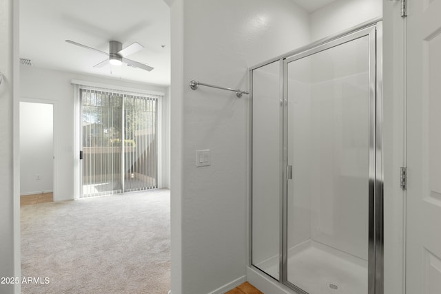 bathroom with visible vents, a stall shower, a ceiling fan, and baseboards