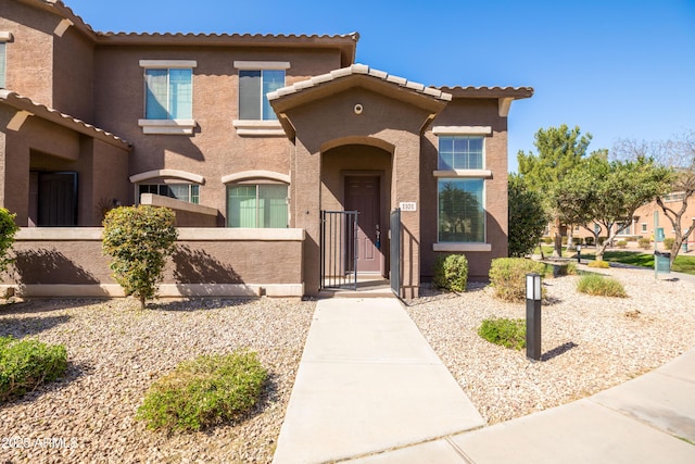 view of front of house with a fenced front yard and stucco siding