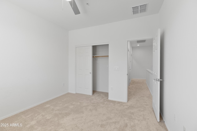 unfurnished bedroom with light carpet, baseboards, visible vents, ceiling fan, and a closet