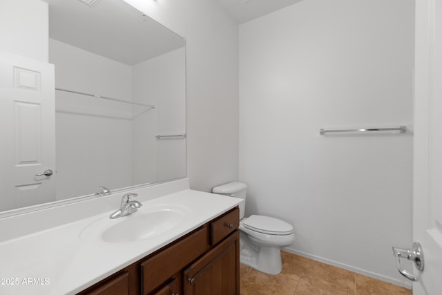 bathroom featuring toilet, tile patterned flooring, baseboards, and vanity