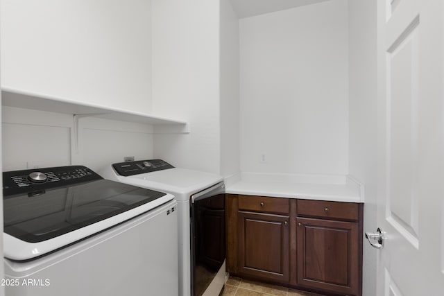 laundry area with washing machine and dryer and cabinet space