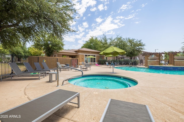 pool featuring a patio, a hot tub, and fence