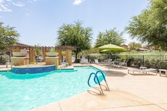 community pool featuring a patio and fence