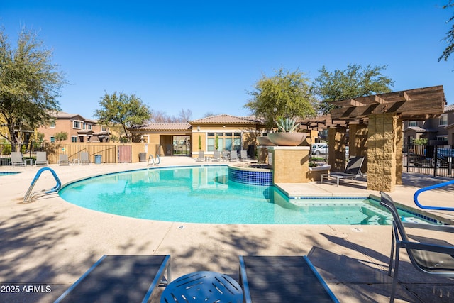 community pool featuring a patio, fence, and a residential view