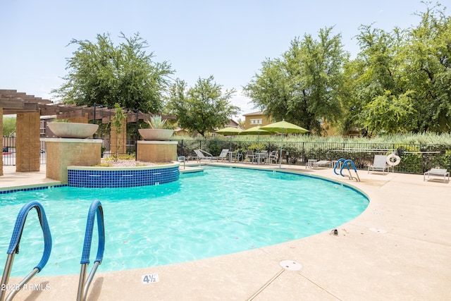 community pool featuring a patio and fence