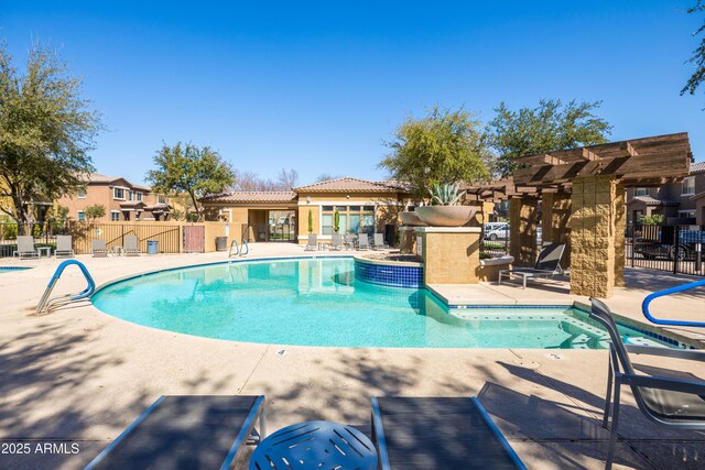 pool with a residential view, a patio area, and fence