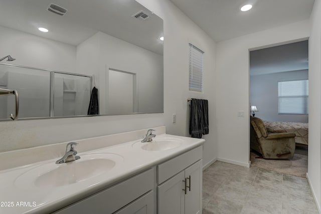 bathroom featuring vanity and a shower with shower door