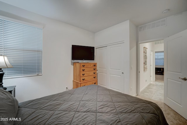 carpeted bedroom with a closet