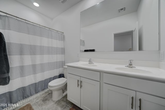 bathroom with walk in shower, tile patterned floors, vanity, and toilet