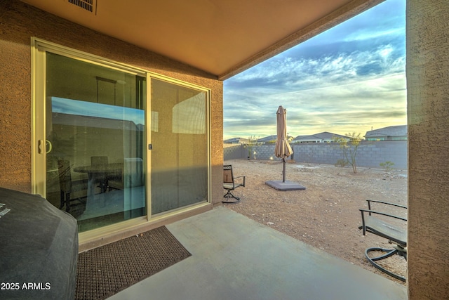 view of patio terrace at dusk